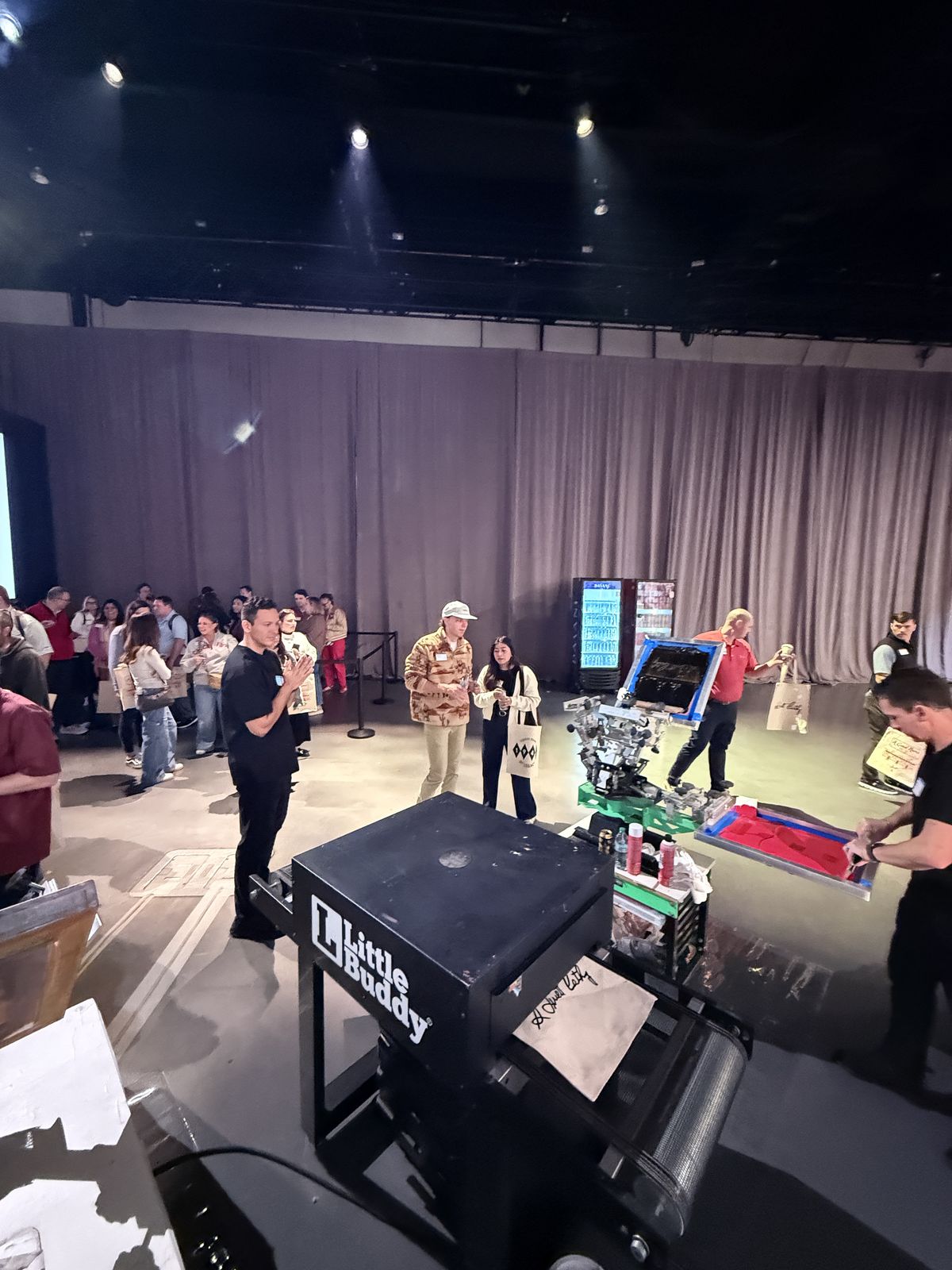 Guests watching custom merch get printed live at a Washington event